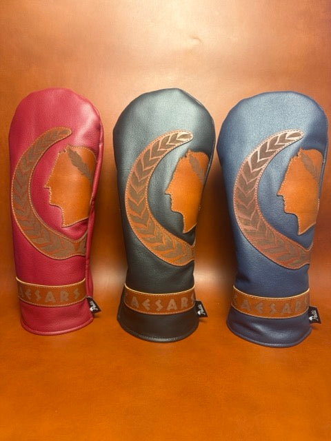 Three Caesars driver covers in red, black and navy leather with a laurel-wreath profile inlay