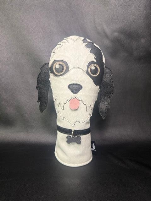 Custom driver cover made to look like a shaggy black-and-white dog, with collar and bone tag